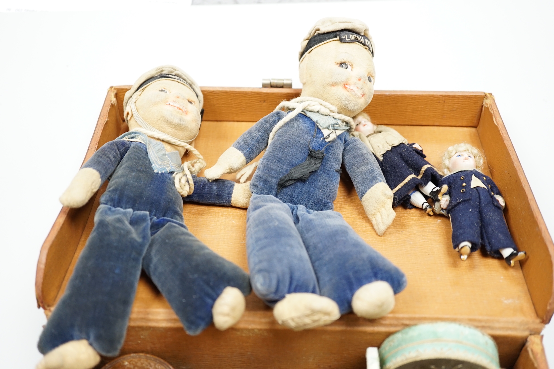 Two miniature bisque headed dolls, two sailor boy dolls and a collection related collectables,(a quantity)